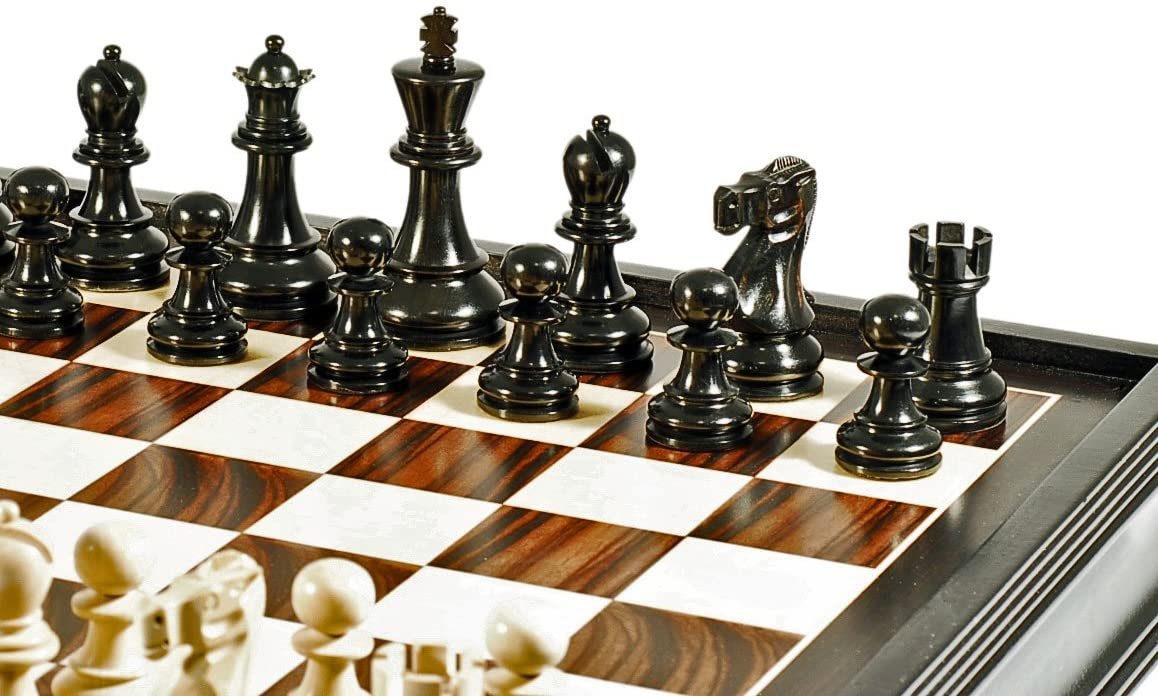 Zoomed in on Black Stained chess pieces on chess board.