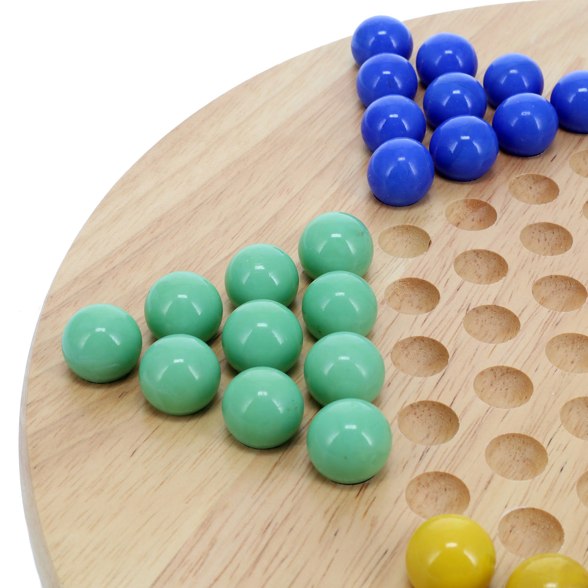 Wooden Chinese Checkers game board with green, blue, and yellow glass marbles on a white background