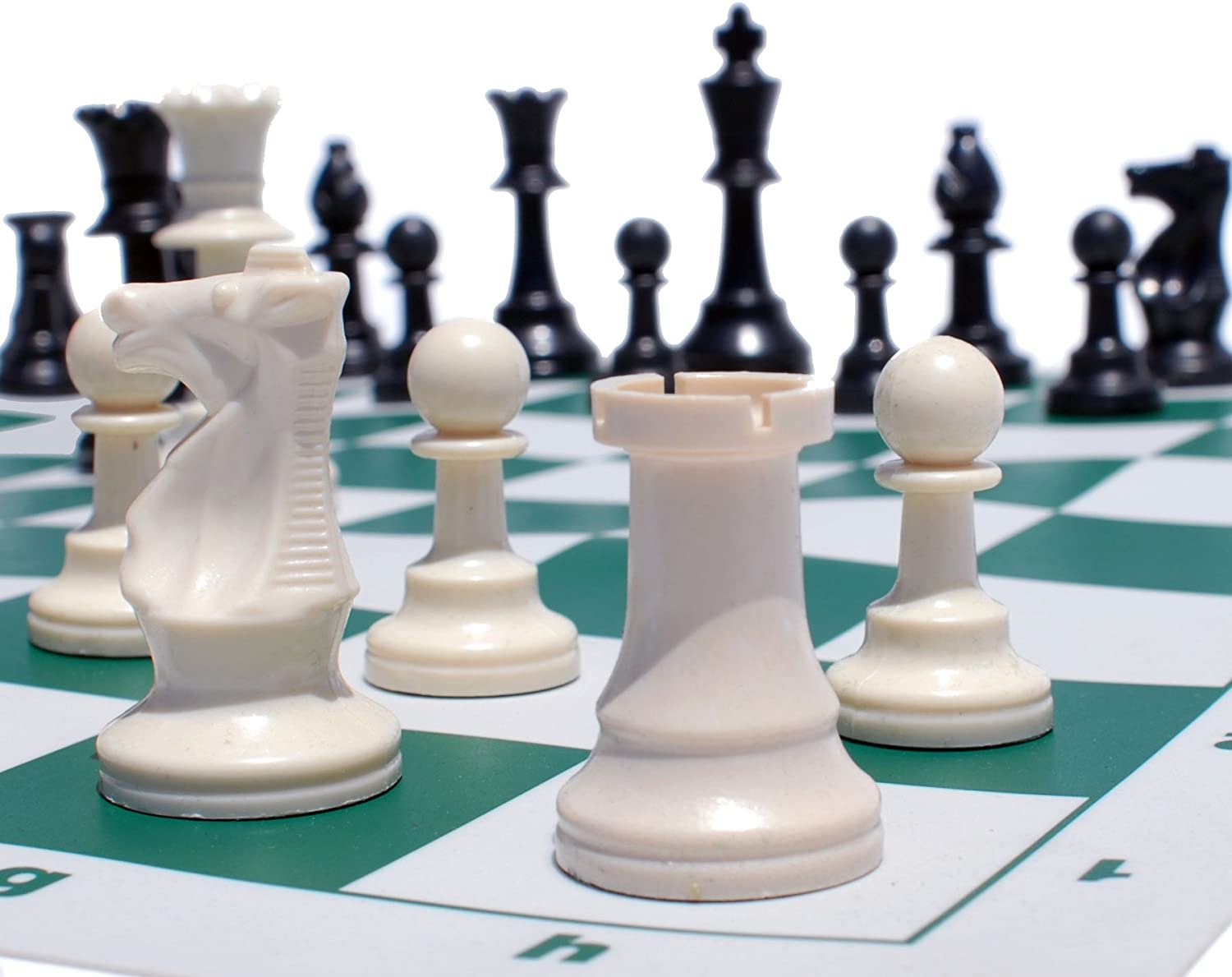 Zoomed in on white chess pieces on vinyl chess board.